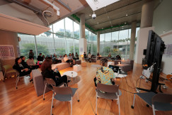 The picture presents people during the workshop.
