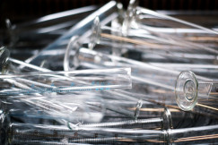 Photo presents a pile of clear measuring test tubes
