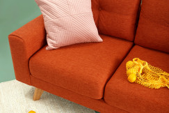 Modern sofa with upholstered textile fabric and decorative cushion, illustrating the use of high-quality textile materials in home furnishing and interior textiles.
