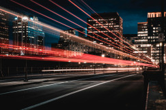 A picture presents a city street at night with light trails.