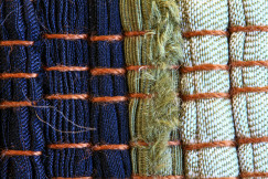 Close-up of woven textile samples in different colours and textures, representing textile materials, circular design and sustainable innovation in the textile industry.