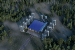 Colour photograph of an aerial view of a building in the middle of a forest.