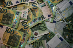A pile of Euro (EUR) banknotes that include 100 notes. 