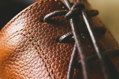 A close up of a brown leather shoe.