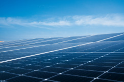 A photo presenting rows of solar panels beneath a clear blue sky.