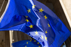 Two EU flags in front of a building. 