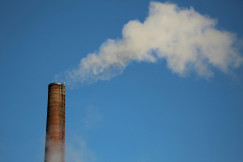 The photo presents smoke coming from an industrial chimney.