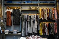 The photo presents clothes displayed in a retail store.