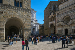 The photo presents a busy square surrounded by historic buildings.