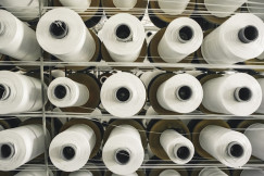 A rack of rolls of white paper in a store.