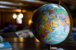 The photo presents a globe showing the Middle East.