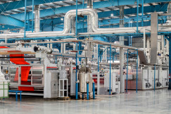 Modern textile manufacturing facility with industrial machinery, fabric processing equipment and production lines
