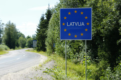 The photo presents a road sign marking the border of Latvia and the European Union.