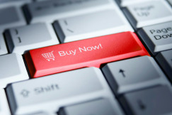 The photo presents a “Buy Now” button on a keyboard.