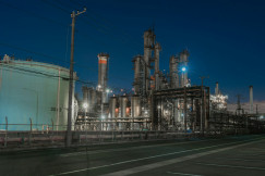 The photo presents an industrial plant at night.