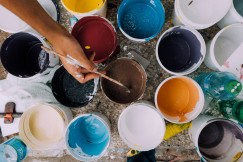 The photo presents colourful buckets of paint.