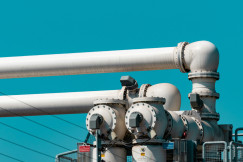 The image depicts industrial pipeline infrastructure that supports the transport and storage of energy resources.