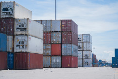The photo shows a number of colourful containers waiting at the port for onward transport.