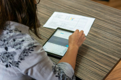 The photo shows lady using tablet.