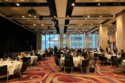 A group of people sitting at tables.