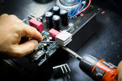 The photo shows working in electronics shop.