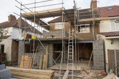 The picture describes a residential building extension and renovation project under construction.