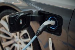 The photo shows an electric car being charged.