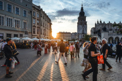 The photo presents tourists on Main Market Square in Krakow, Poland.