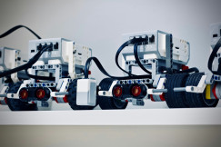 The picture shows a row of small educational robots built from modular components.