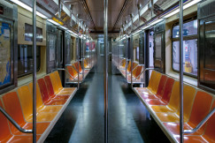 The photo shows the interior of an empty subway car.