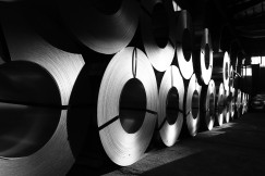 The photo presents rolled metal coils.