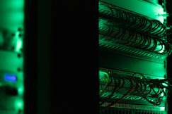 The photo presents network cables in a server room.