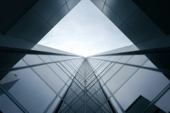 The picture describes a modern glass office building.