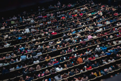 A large group of people sitting in a theatre.