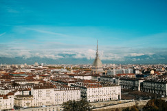 The photo presents a panoramic view of Turin, Italy, with the Mole Antonelliana in the centre.