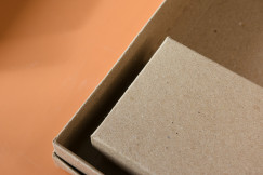The photo presents close-up cardboard packaging made from recycled paper.