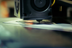A close up of a 3D Machine on a table.