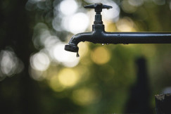 The photo presents a dripping water tap.