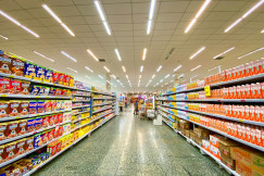 The photo presents a supermarket aisle filled with food products.