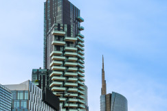 The picture shows a modern urban district in Milan, Italy, characterized by contemporary high-rise architecture and extensive glass façades.