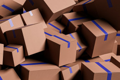 The photo presents a pile of cardboard boxes.