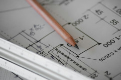 The photo presents a technical drawing with a pencil and ruler.