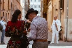 An illustrative photo of two people standing in the middle of a street.