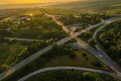 An illustrative photo of a road between trees