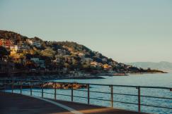 An illustrative photo of a body of water with a hill in the background.