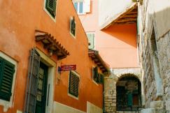 An illustrative photo of a coastal town with terracotta-roofed buildings and a marina