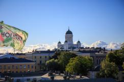 An illustrative photo of a flag flying in the air over a city