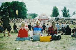 An illustrative photo of a group of people on grass field