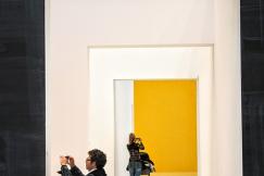 An illustrative photo of tourists taking pictures in museum