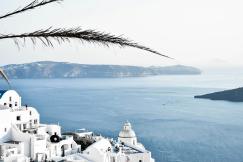 An illustrative photo of white concrete buildings near ocean during daytime.